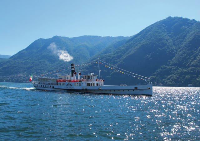 Cruise in the middle of Lake Como and mountains in the background