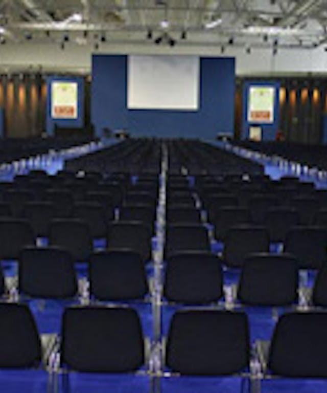 Fiera di Roma meeting room with black chairs and blue floor