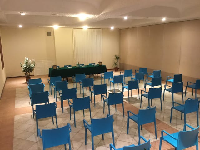 Meeting room with blue chairs and white walls