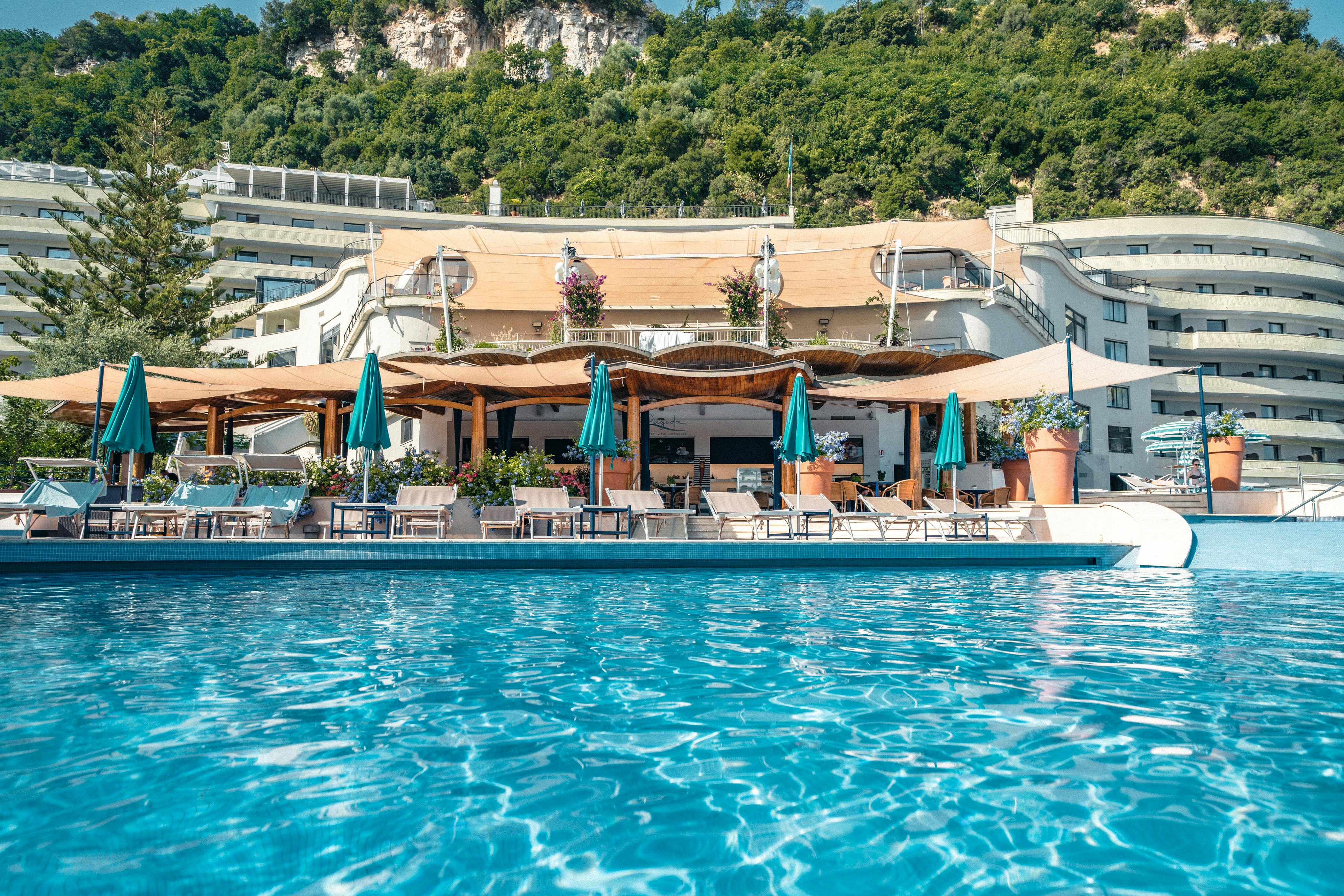 Swimming pool with house and umbrellas