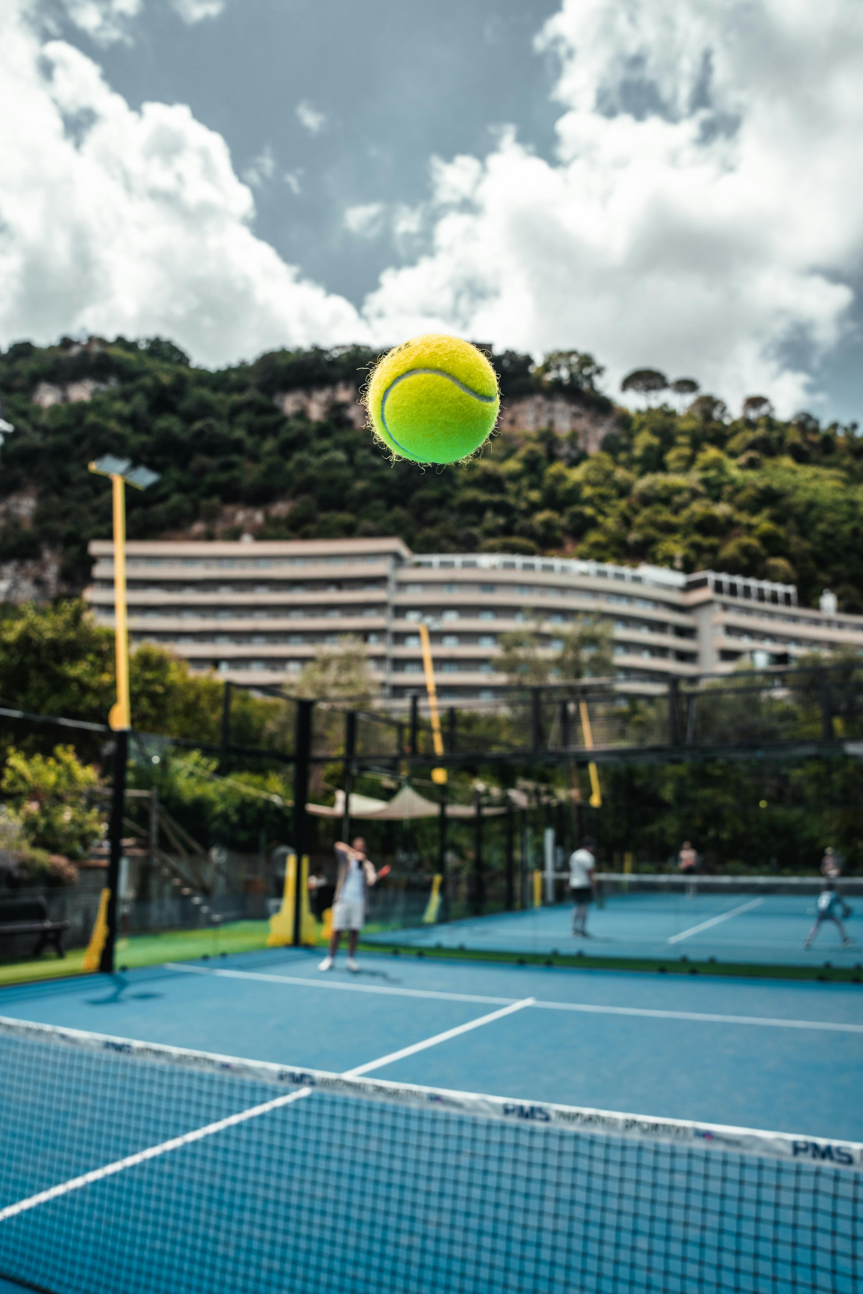 Tennis court with yellow ball