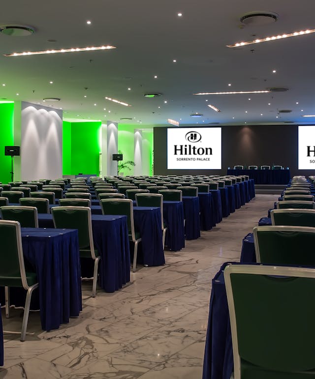 Meeting room with blue tables and green chairs