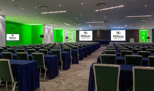 Meeting room with blue tables and green chairs