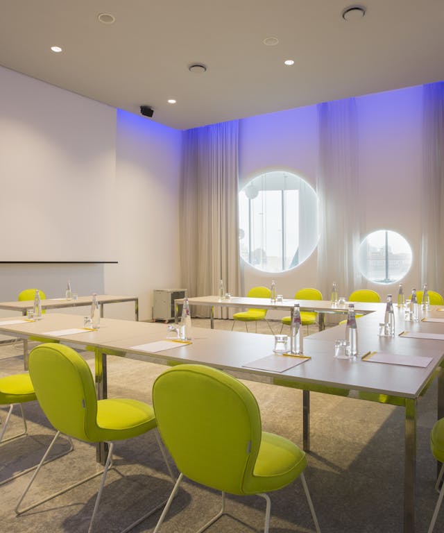 Meeting room with yellow chairs and white walls