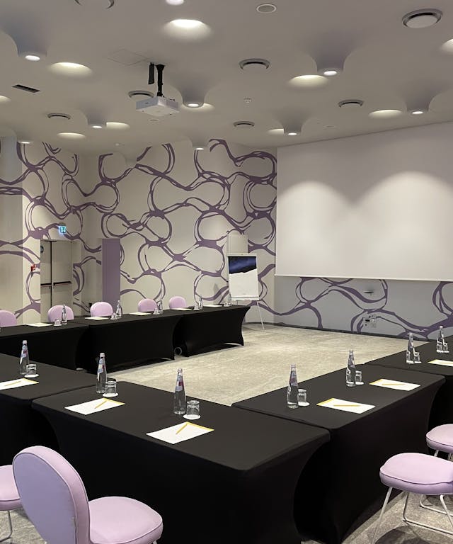 Meeting room with black table and white chairs