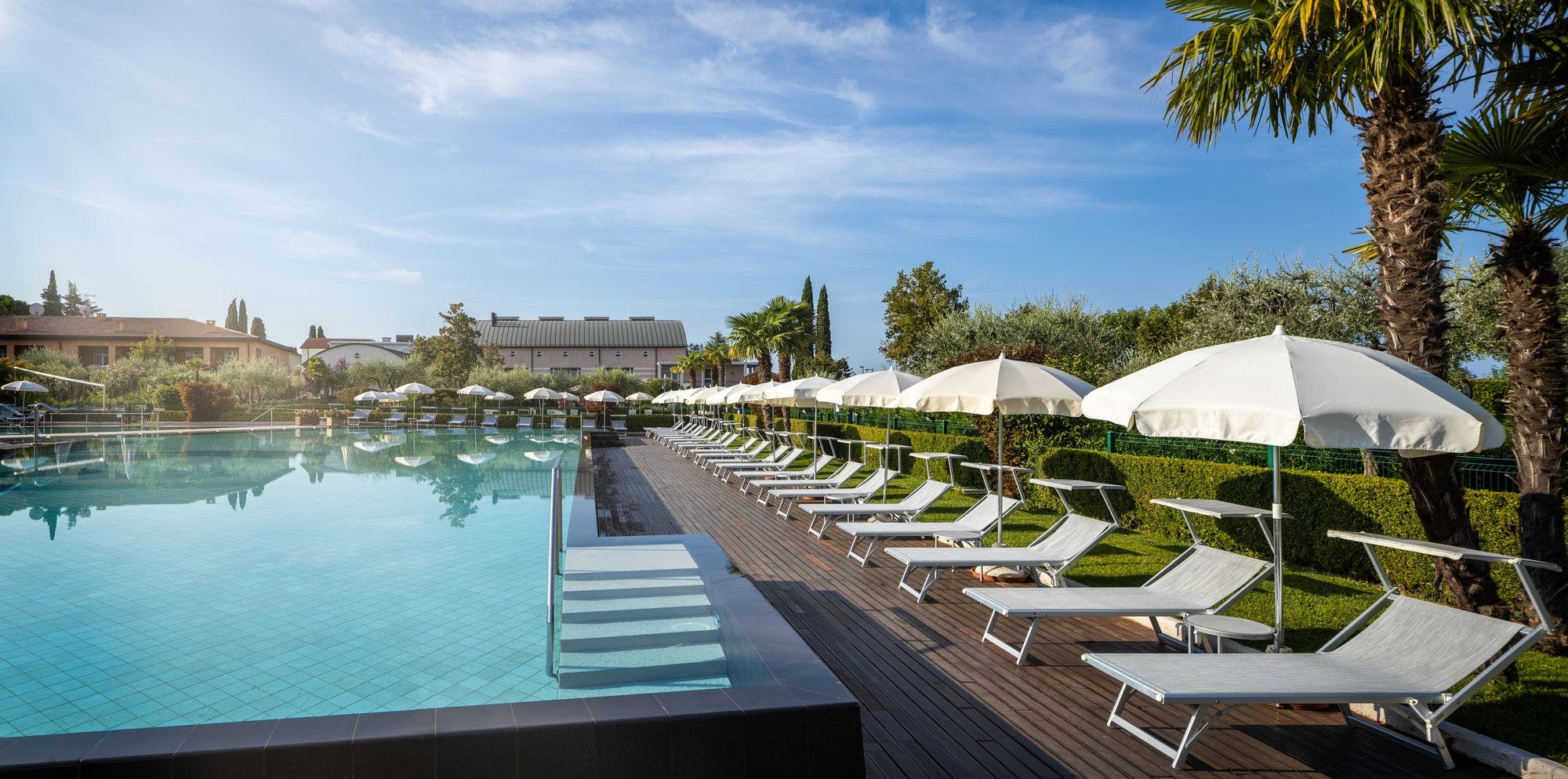 Swimming pool-umbrellas-sun-blue sky-hotel