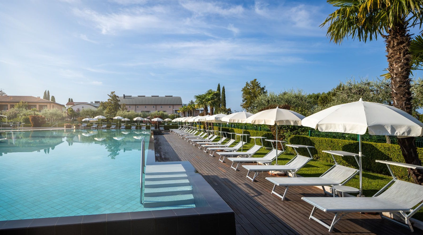 Swimming pool-umbrellas-sun-blue sky-hotel