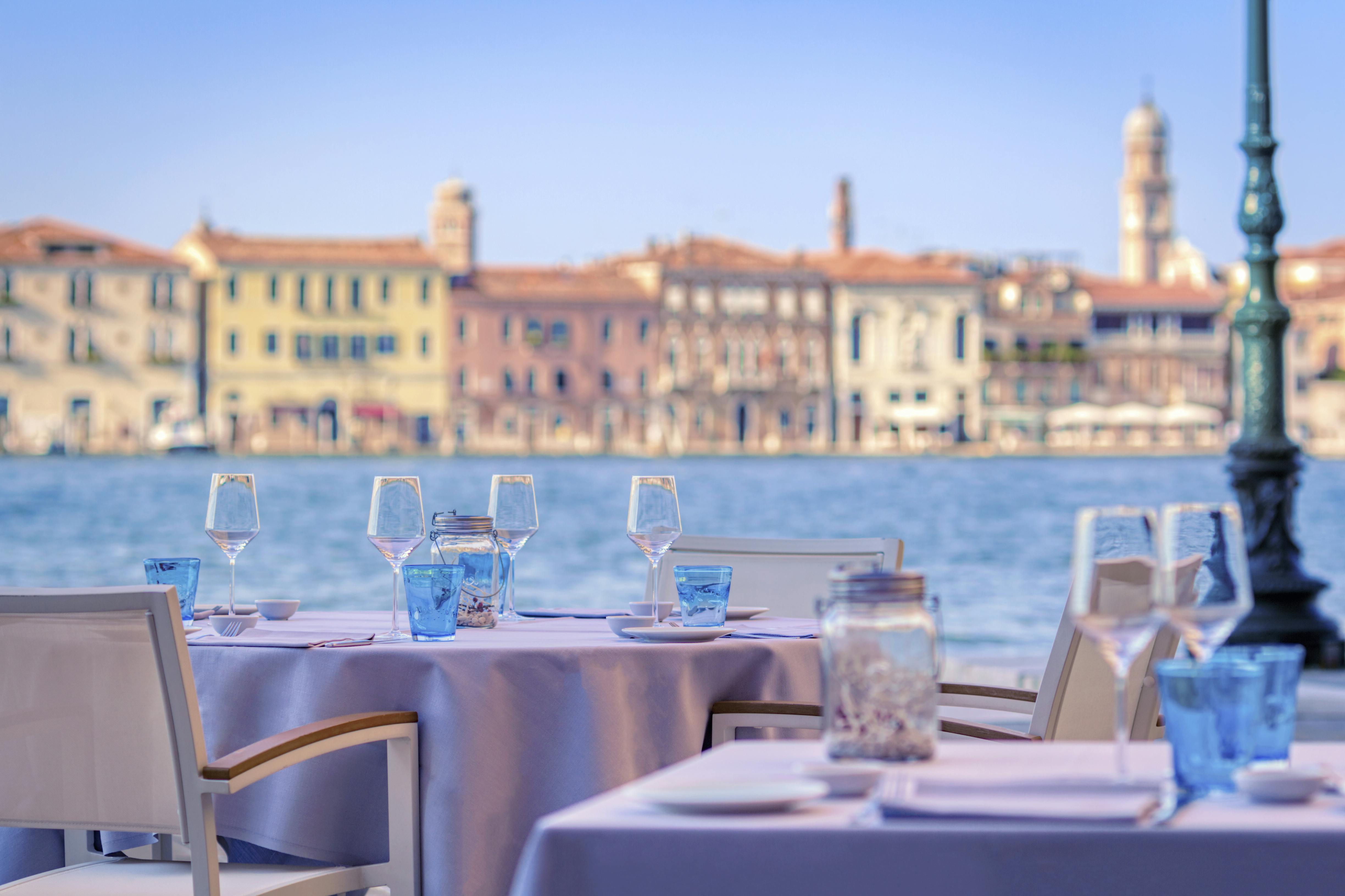 Tables with white appliances and sea in the background