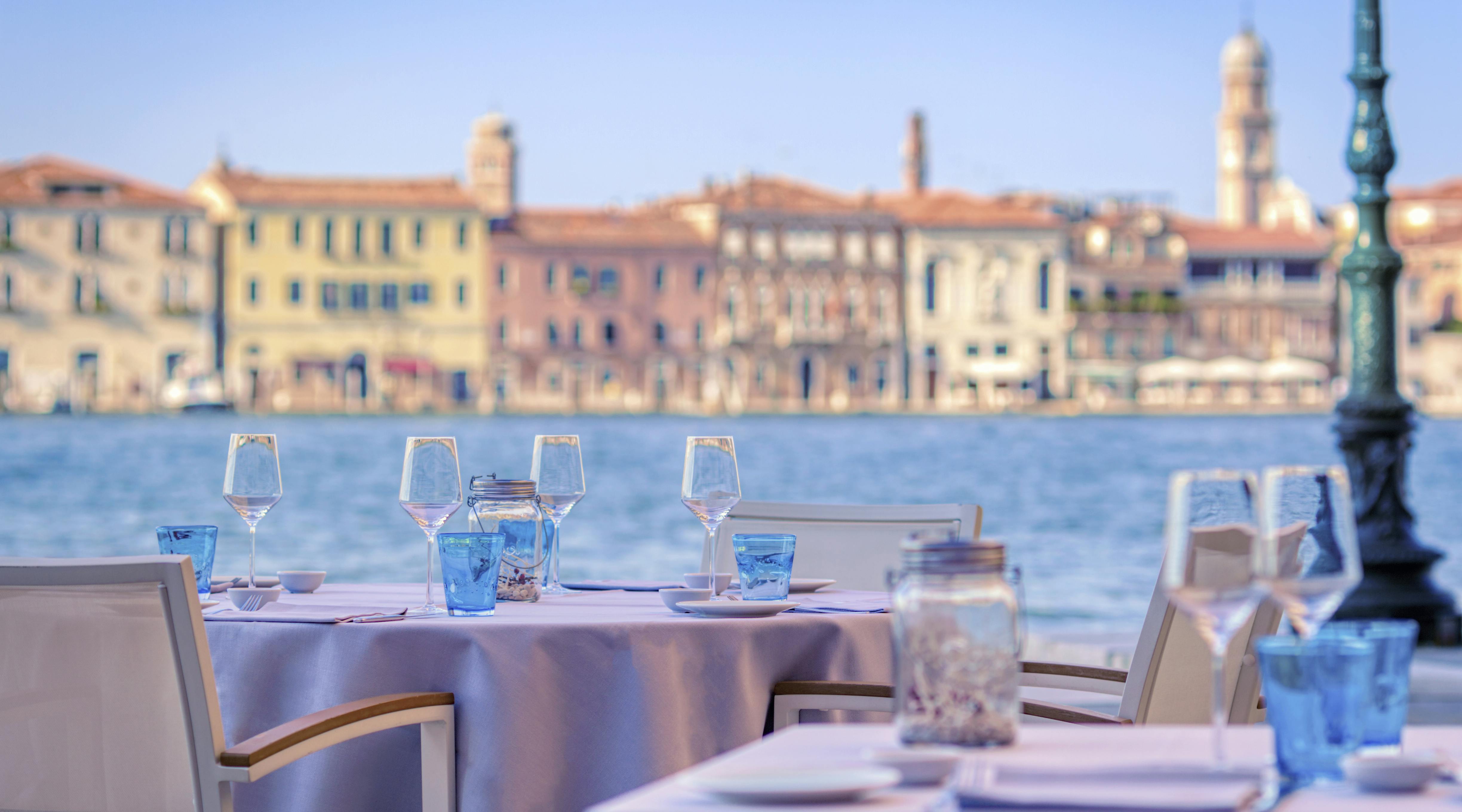 Tables with white appliances and sea in the background