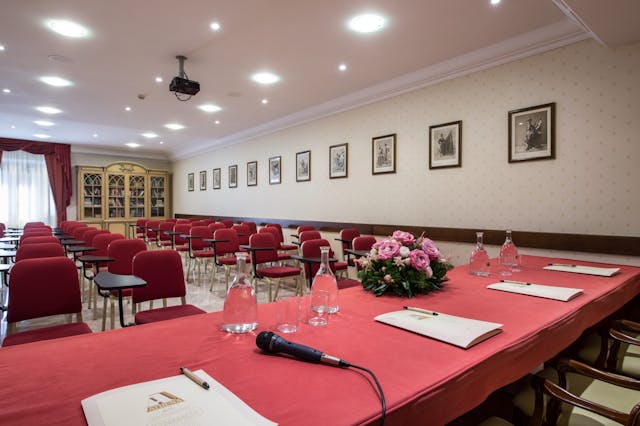 Meeting room with red table and chairs and flowers