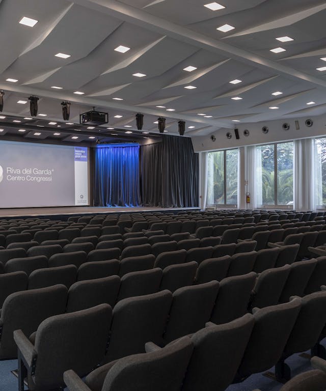 Conference center with black chairs and screen