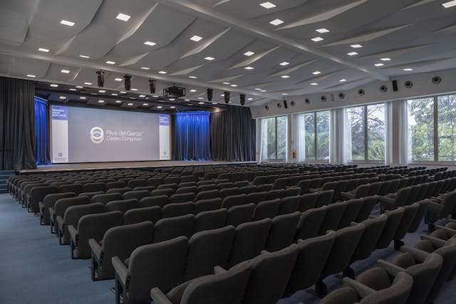 Conference center with black chairs and screen