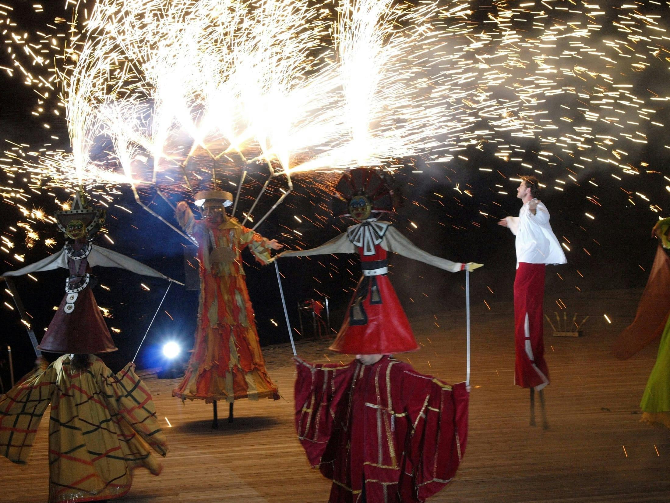 Show with fire and stilt walkers