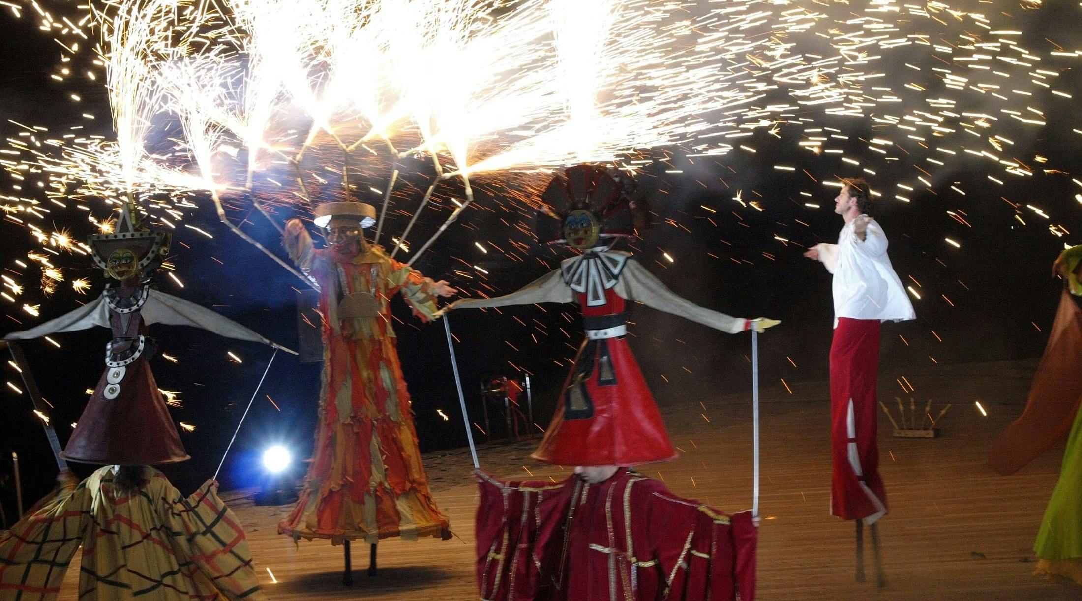 Show with fire and stilt walkers
