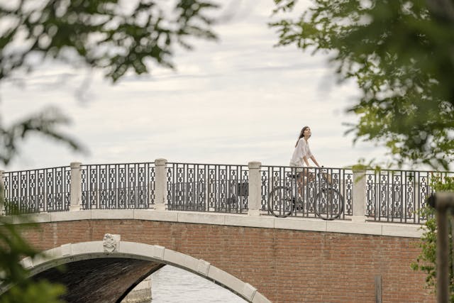 girl on bike on a bridge