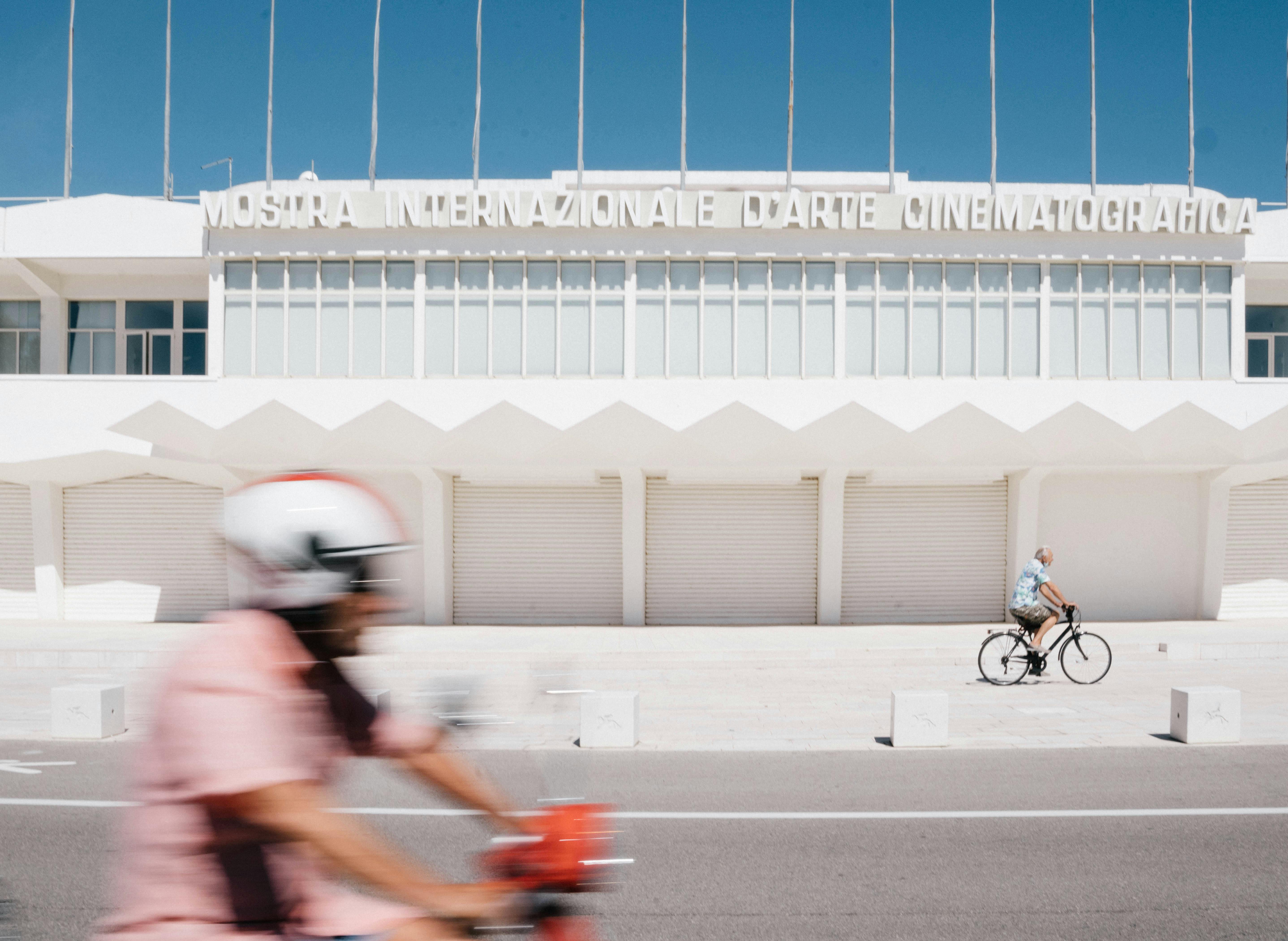 building and people on bikes