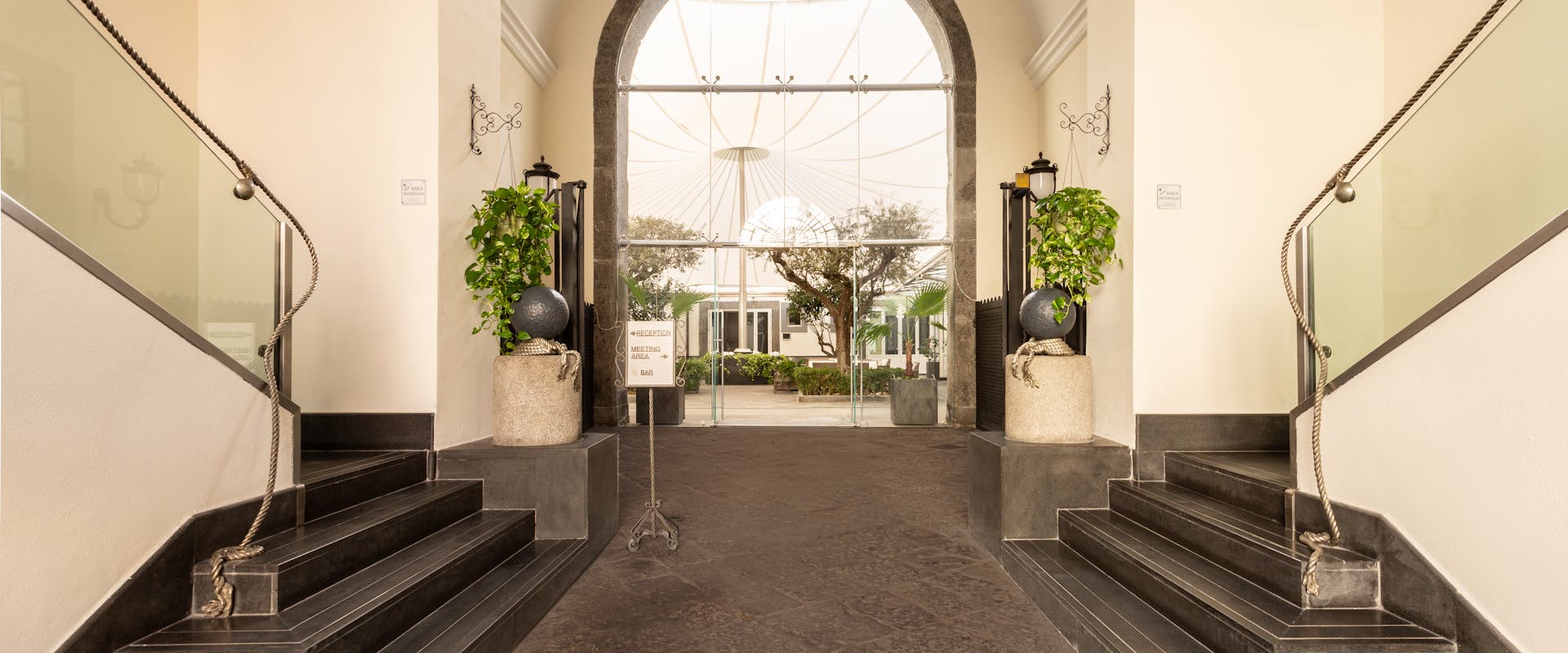 Palazzo Caracciolo Naples hotel entrance with stairs