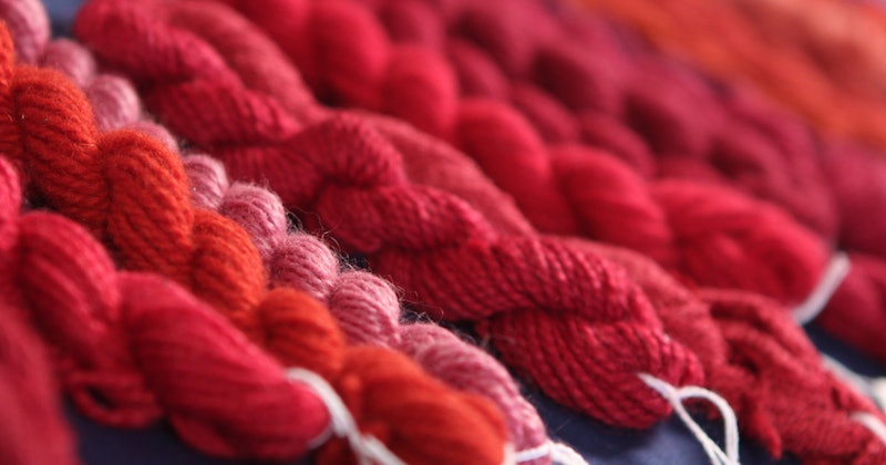 Dagmar Klos shows how changing the pH of the dyebath shifts cochineal from deep purple-red to orange-red in her video, Natural Dyeing with Dagmar Klos. Photo courtesy of Long Thread Media