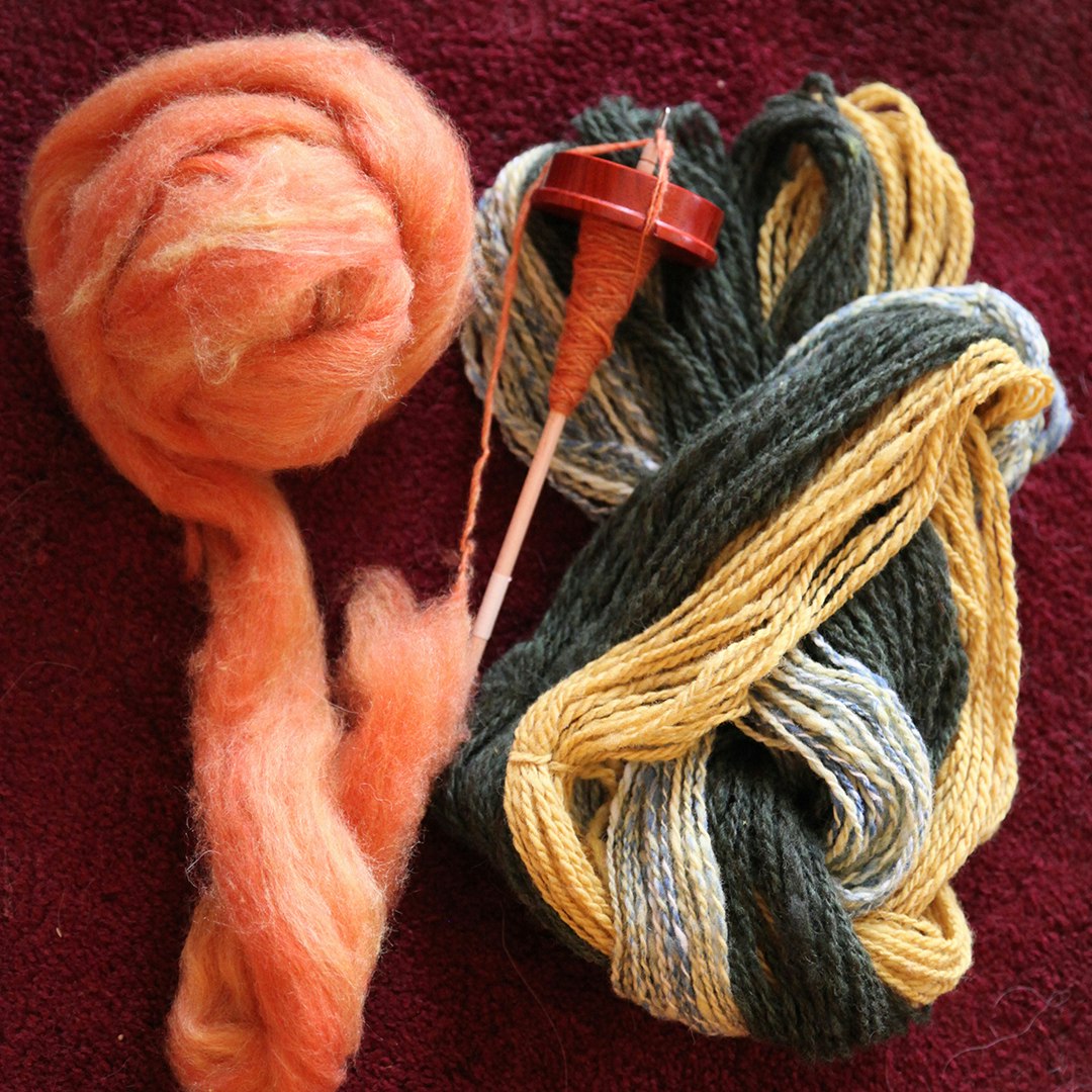 Peach roving, drop spindle, and plied bulky yarns