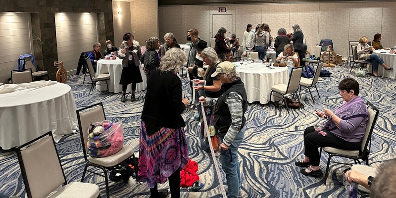 Attendees at SOAR 2022 enjoy reading the sayings on Jeannine’s handwoven band at the fashion show and spin-in. Photos by Tiffany Warble