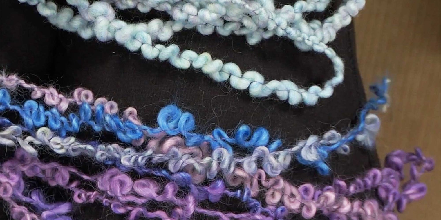 Sarah Anderson shows us how different fibers and thicknesses result in different bouclé yarns. The suri alpaca fiber turned into loops (purple and blue yarns, bottom), while the Merino puffed up and created little bumps and zigzags (light green, top). Photo from Building Blocks of Spinning by Long Thread Media