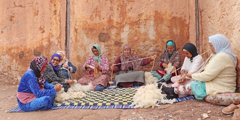 The artisans of the Association Tithrite in Ait Hamza, Morocco, gather outside their workshop to celebrate twiza—the practice of working together to accomplish a labor-intensive task. Photo by Yassine Bouhouch