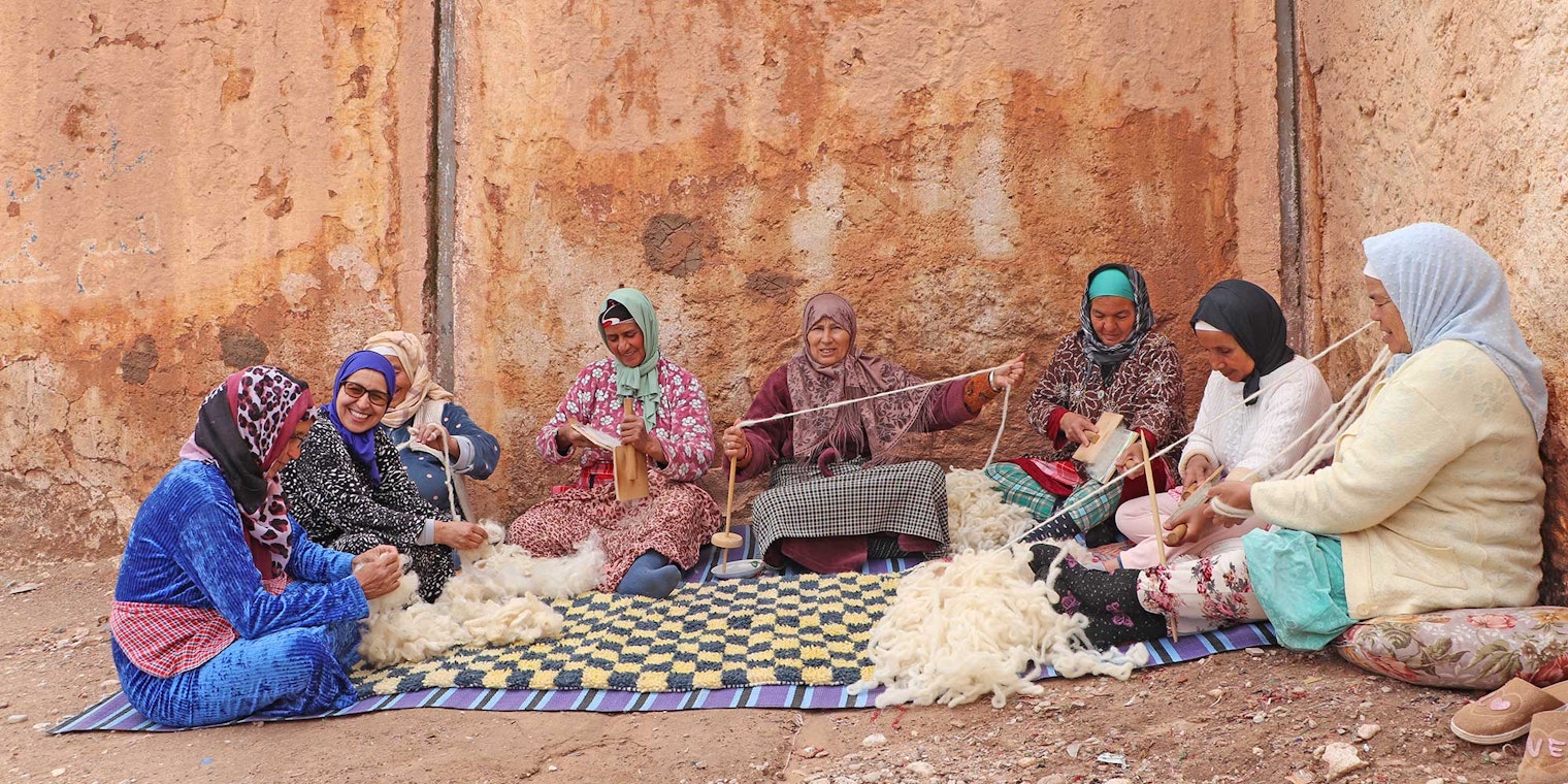 The artisans of the Association Tithrite in Ait Hamza, Morocco, gather outside their workshop to celebrate twiza—the practice of working together to accomplish a labor-intensive task. Photo by Yassine Bouhouch