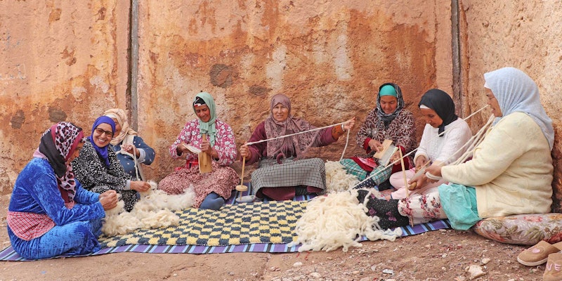 The artisans of the Association Tithrite in Ait Hamza, Morocco, gather outside their workshop to celebrate twiza—the practice of working together to accomplish a labor-intensive task. Photo by Yassine Bouhouch