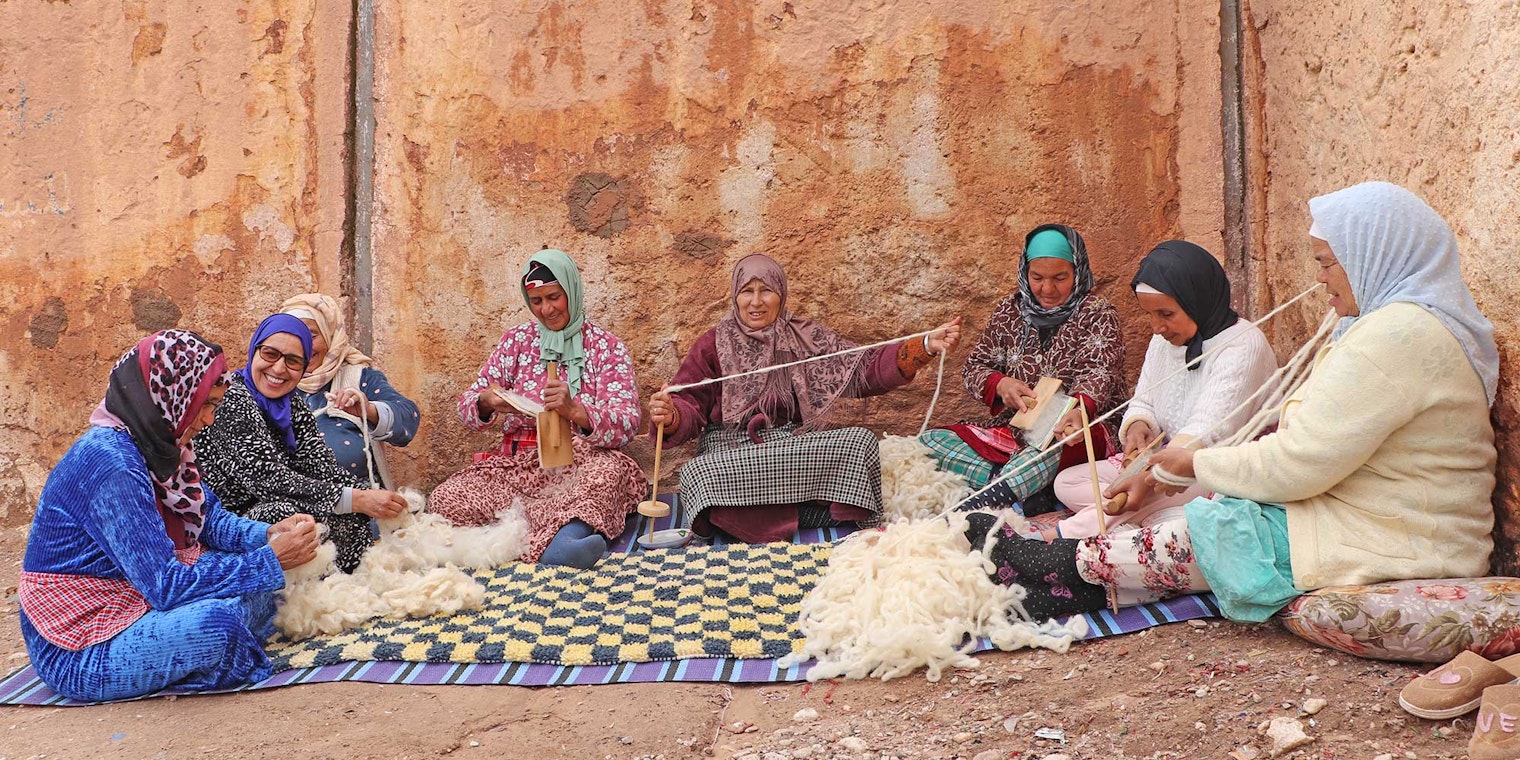 The artisans of the Association Tithrite in Ait Hamza, Morocco, gather outside their workshop to celebrate twiza—the practice of working together to accomplish a labor-intensive task. Photo by Yassine Bouhouch