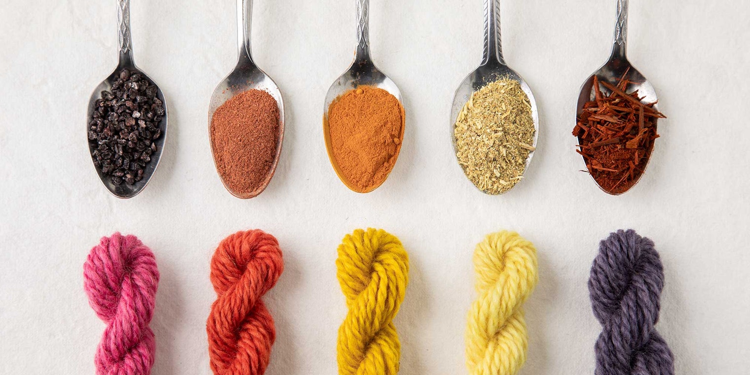spoons holding natural dyestuffs and colored skeins of yarn