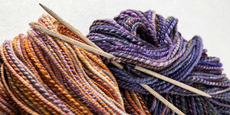 skeins of orange and purple yarns