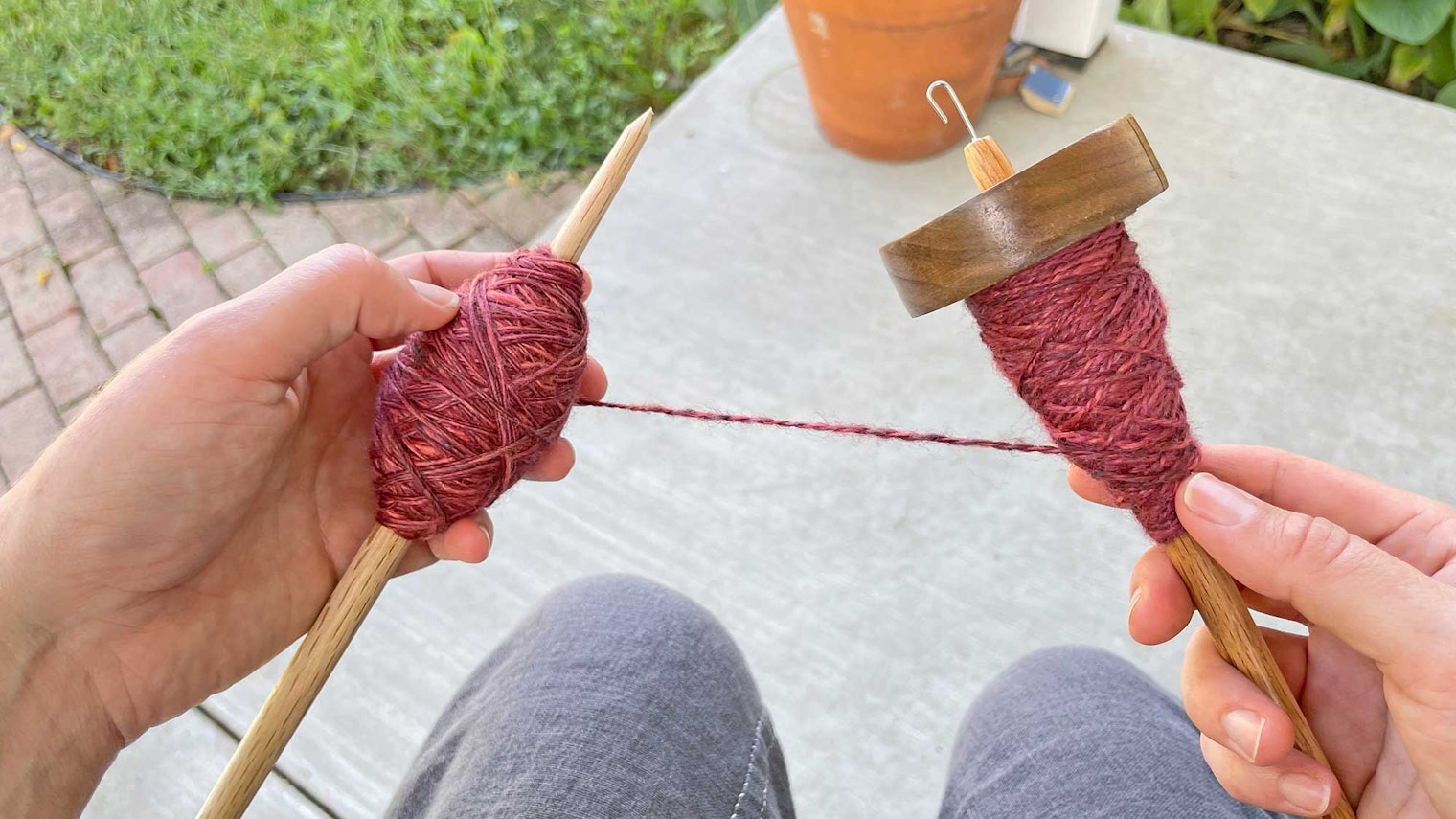 spindle full of red yarn