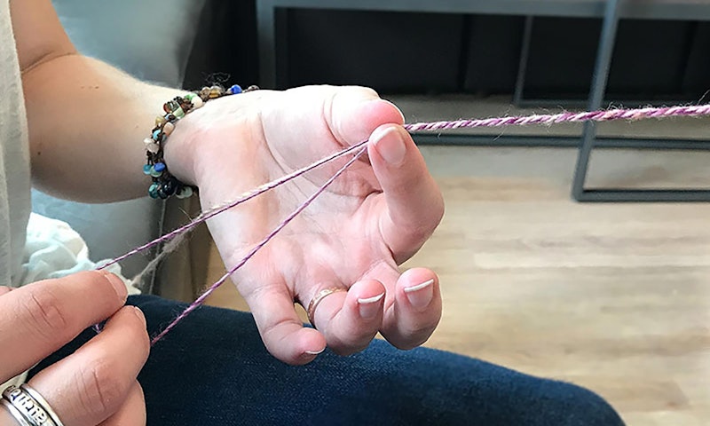hands holding twisted yarn