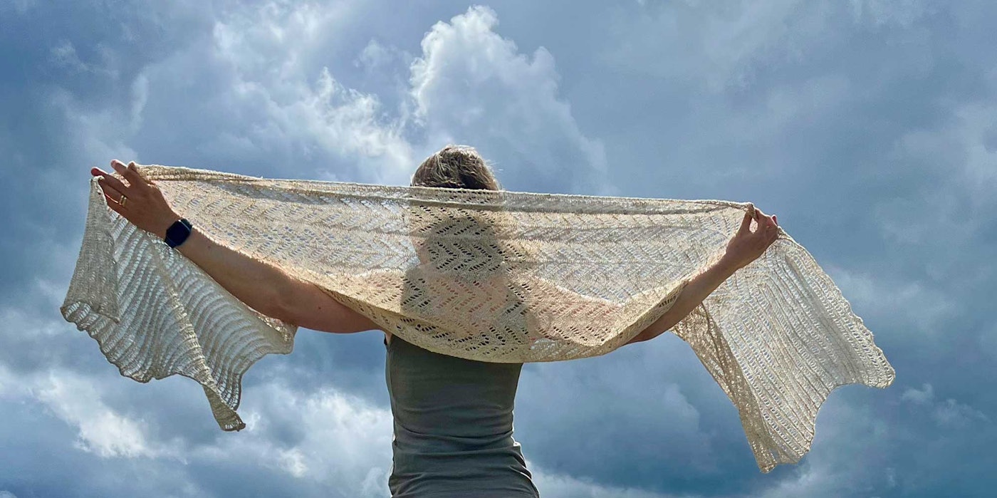 woman wearing off-white knitted shawl