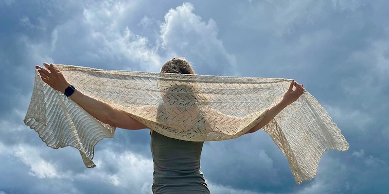 woman wearing off-white knitted shawl