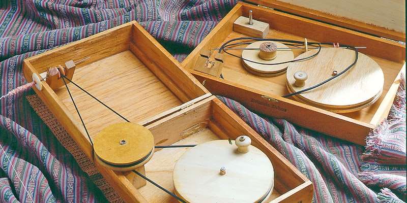 two wooden box charkhas