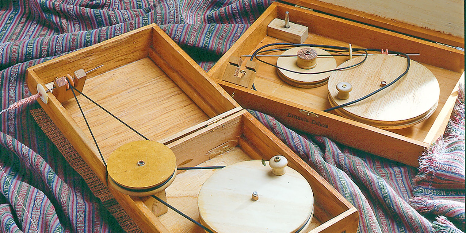 two wooden box charkhas