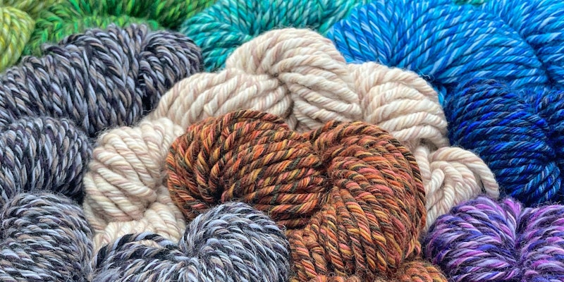 skeins of brown, white, gray, blue, and purple yarns