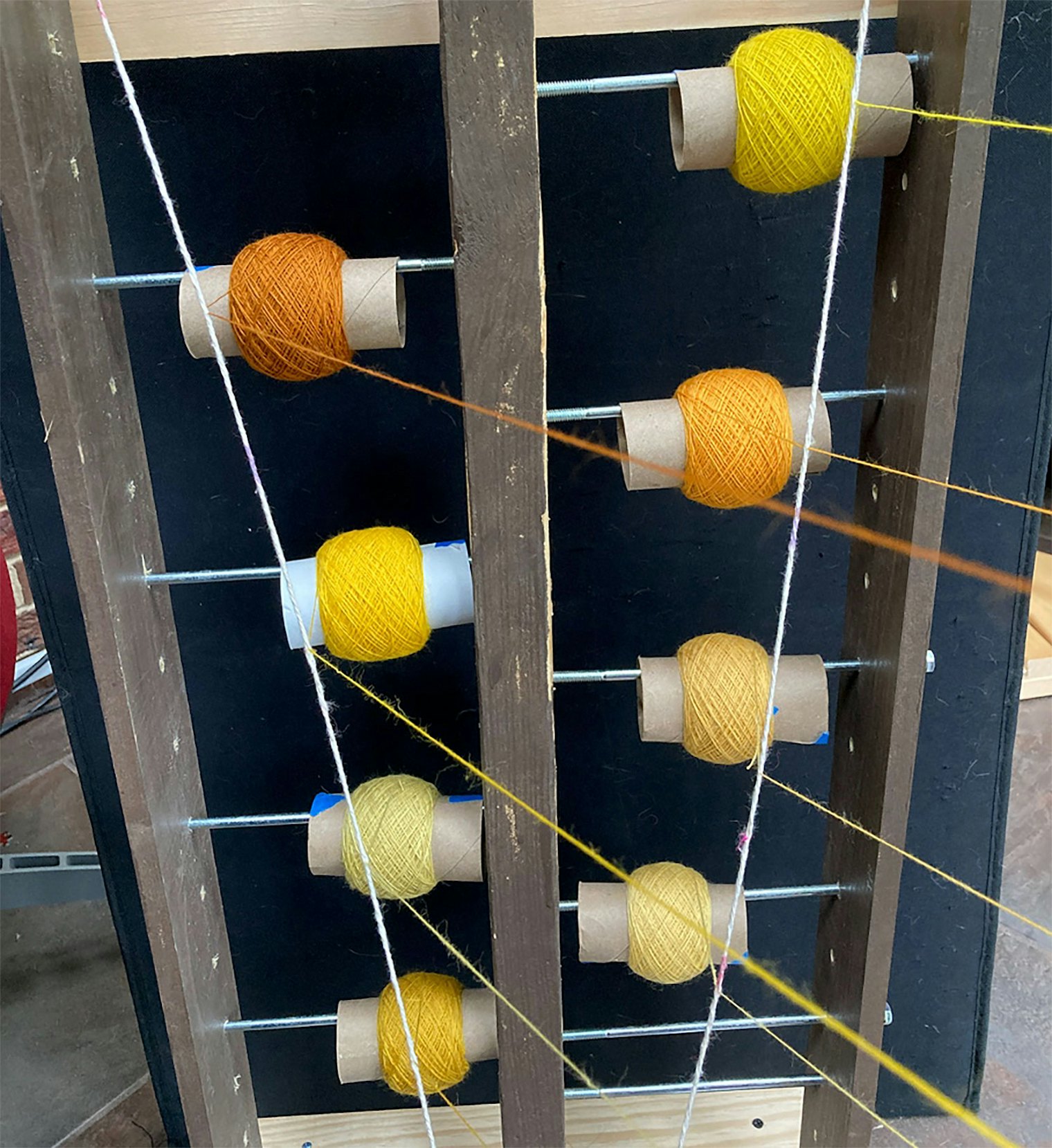 This time, Kat has 8 bobbins loaded to her handmade lazy kate.