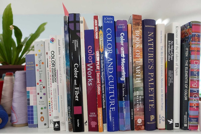 A bookshelf with color theory books.