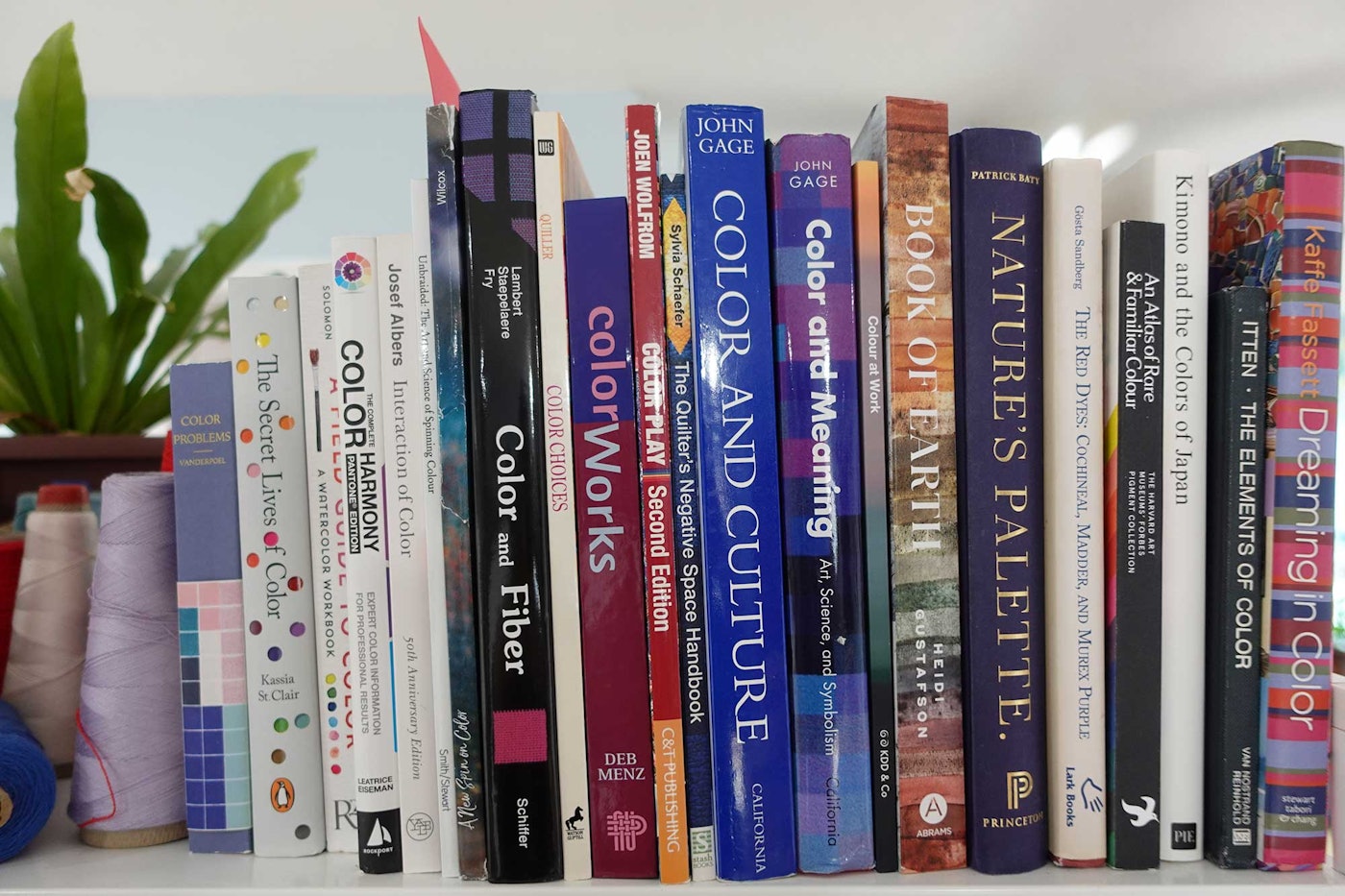 A bookshelf with color theory books.