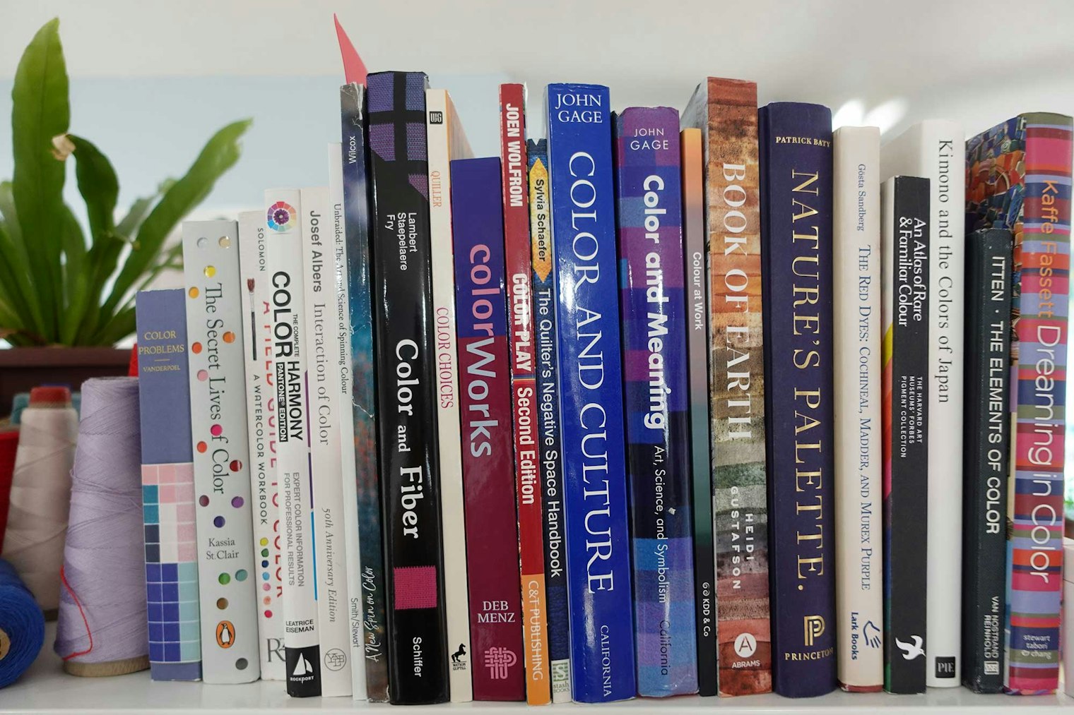 A bookshelf with color theory books.
