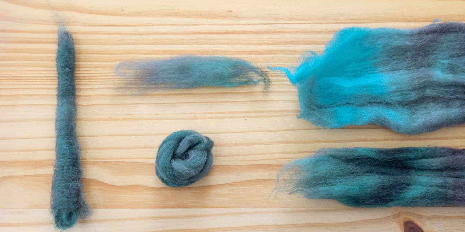 Five fiber preparations from the same braid rest on a wood table.
