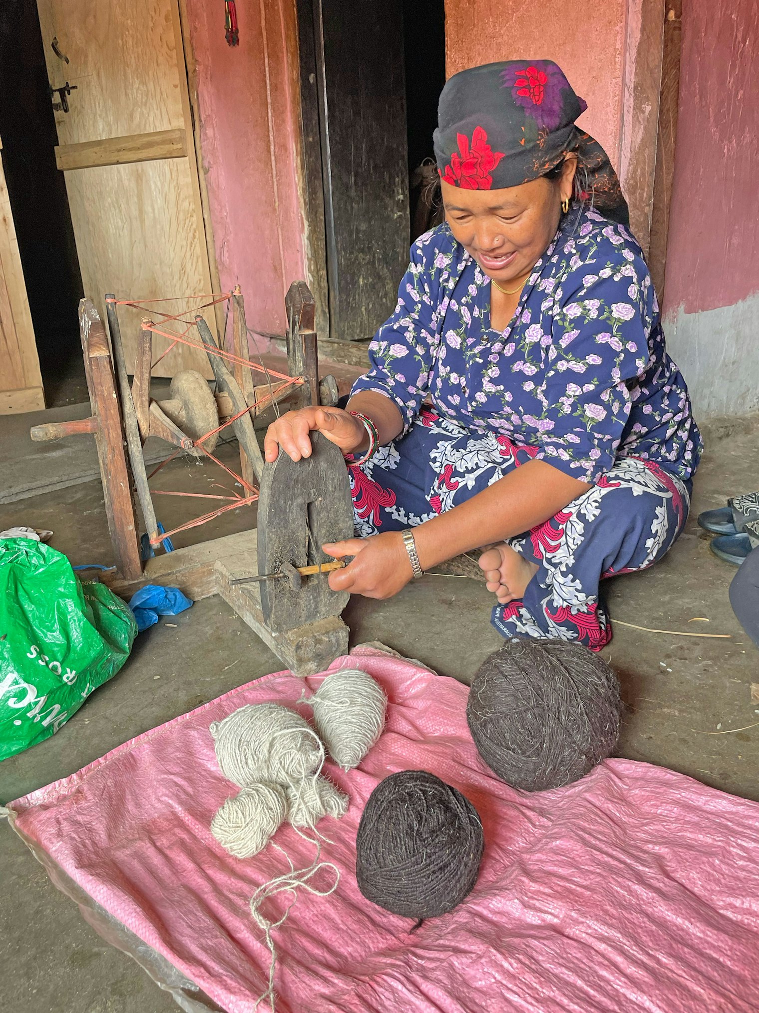 Phul Maya adjusts the spindle on her charkha in Ghalegaun; photo by Sally Conover
