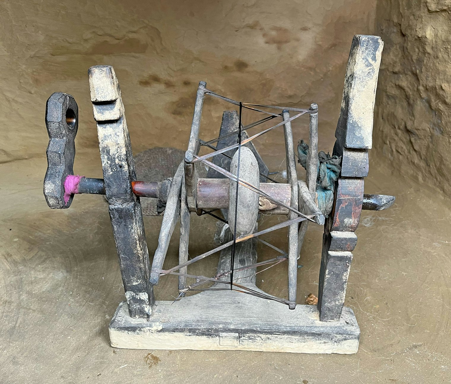 A charkha from the village of Ghalegaun; notice the stone drive wheel.
