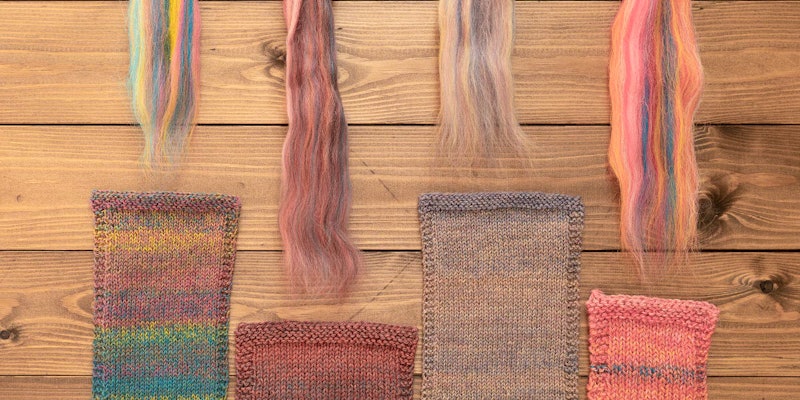 Swatches and fiber rest on a wood surface.