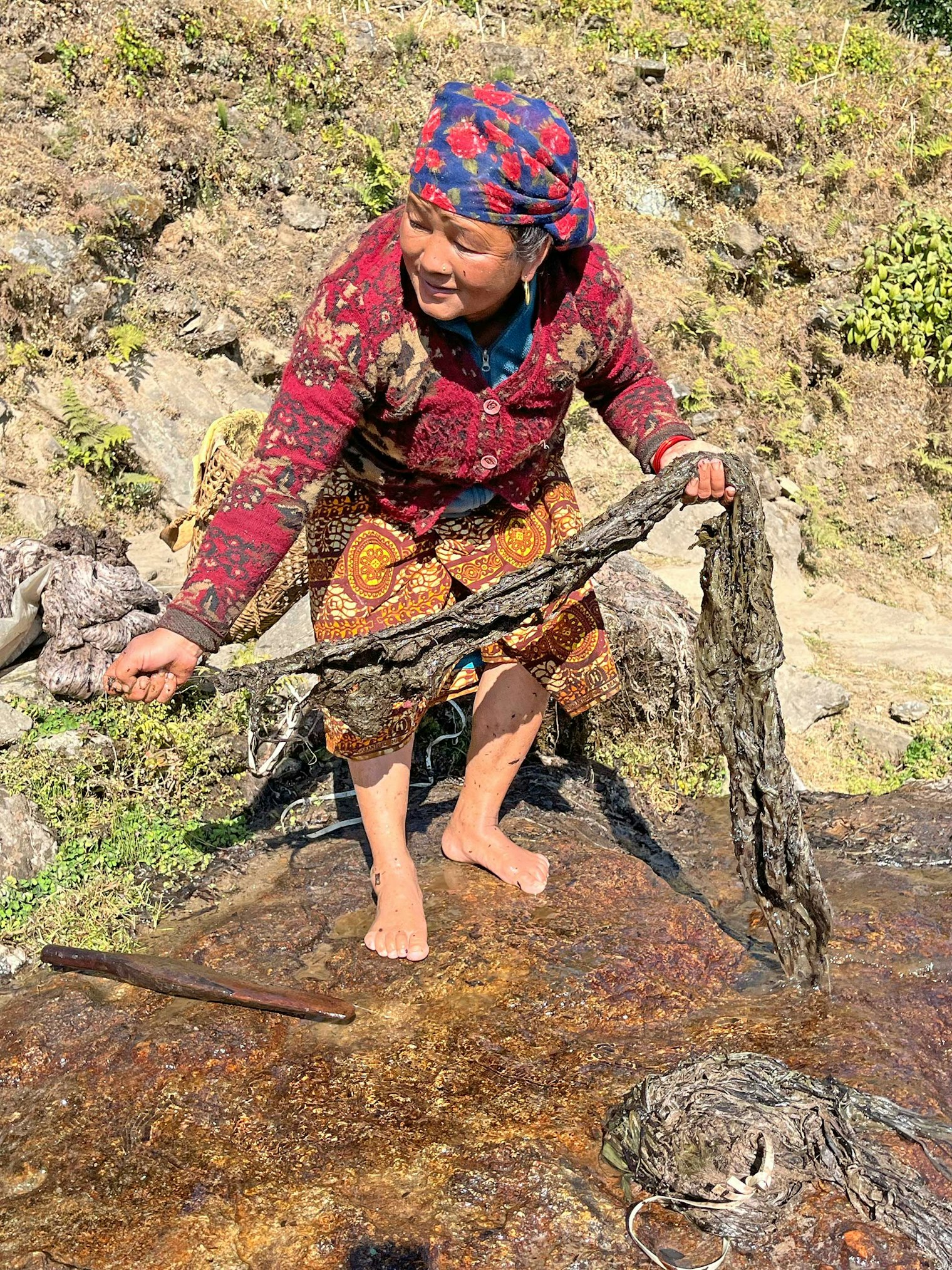 Kanchi Gurung washing the allo. Photo by Karen Brock