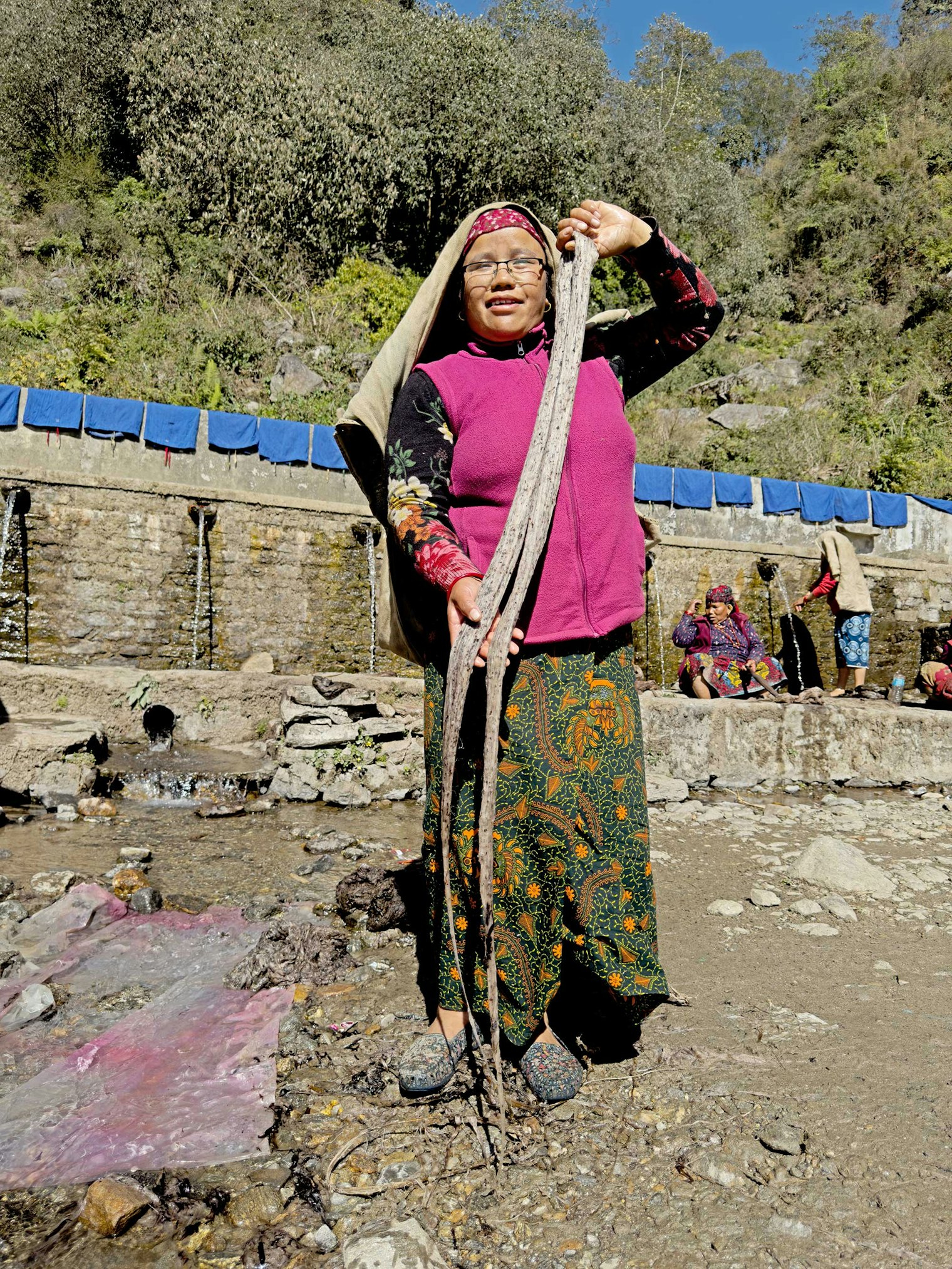 Yaman Suba holding allo that has been beaten with rice. Photo by Kathleen Mahoney