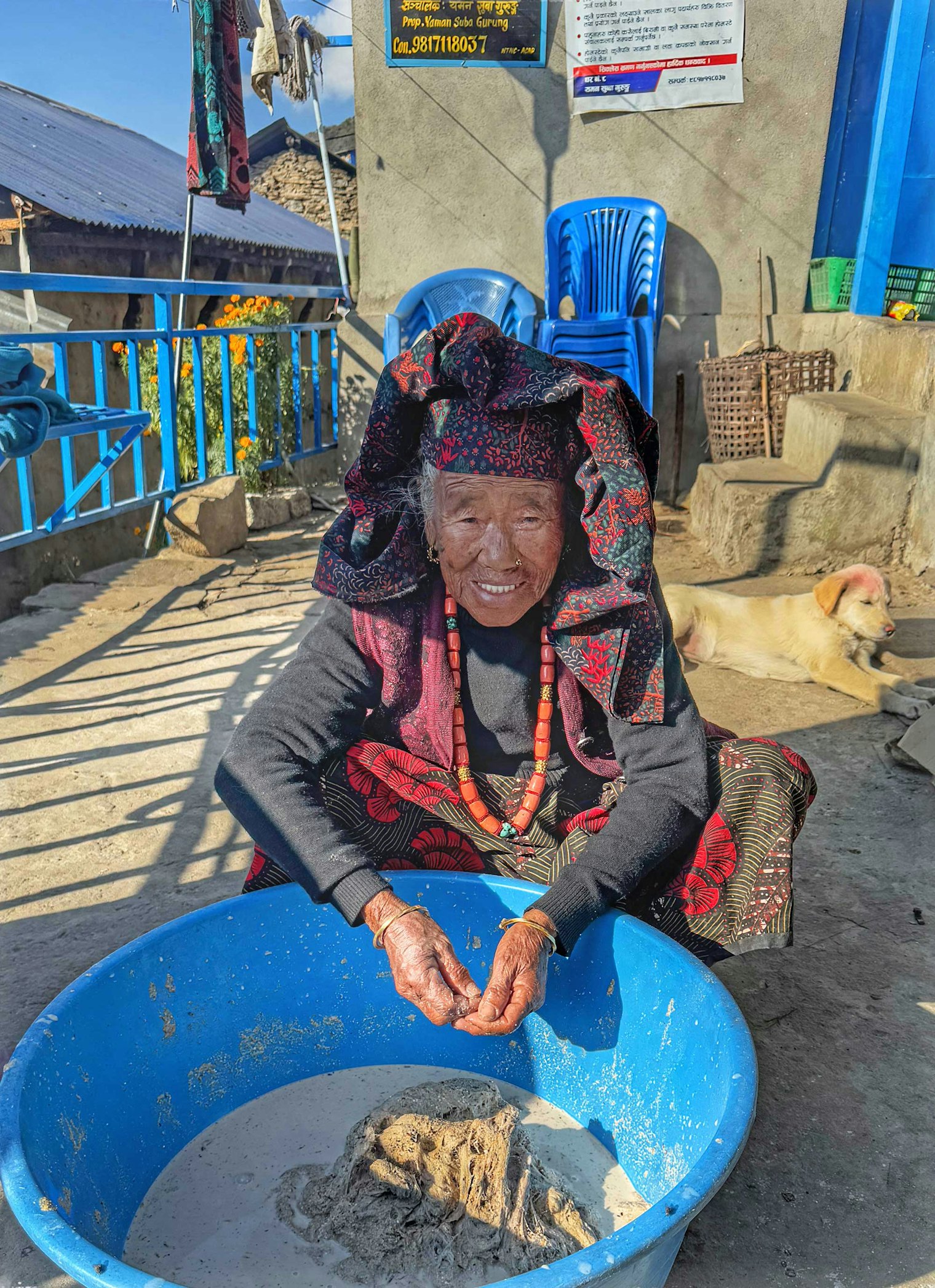 Chandra Kumari mixes allo with ground rice hulls and water. Photo by Kathleen Mahoney