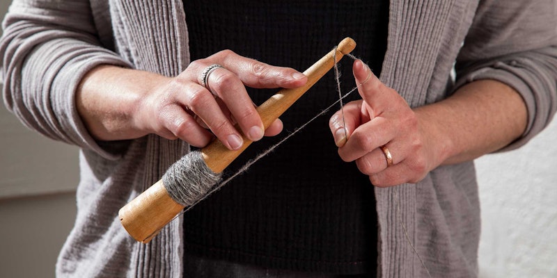 hands holding a spindle